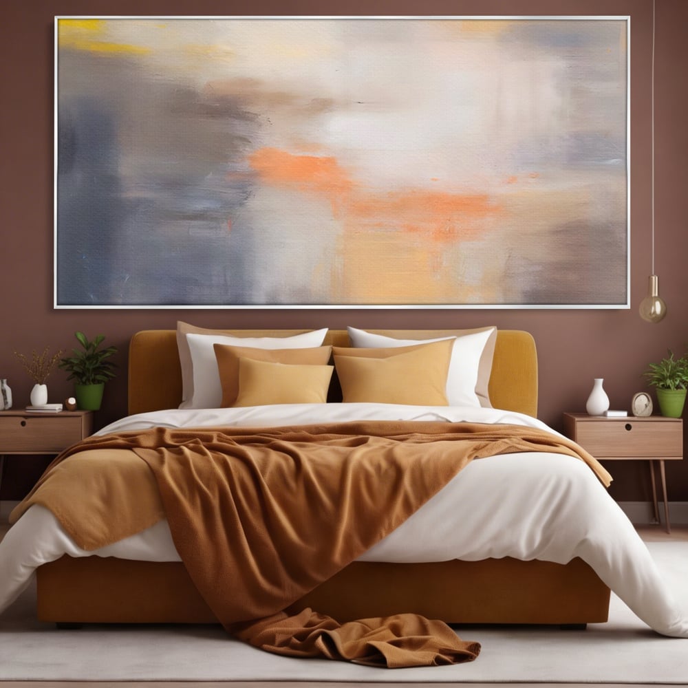Tablou canvas cu pictura abstracta cu pete portocalii, in rama de aluminiu argintiu, pe perete intr-un dormitor